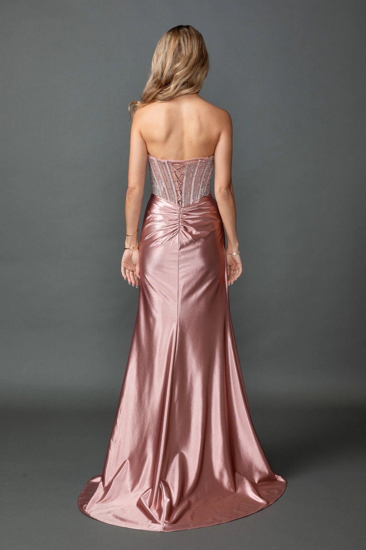 From the back, the Rose Gold prom dress reveals its floor-length skirt.