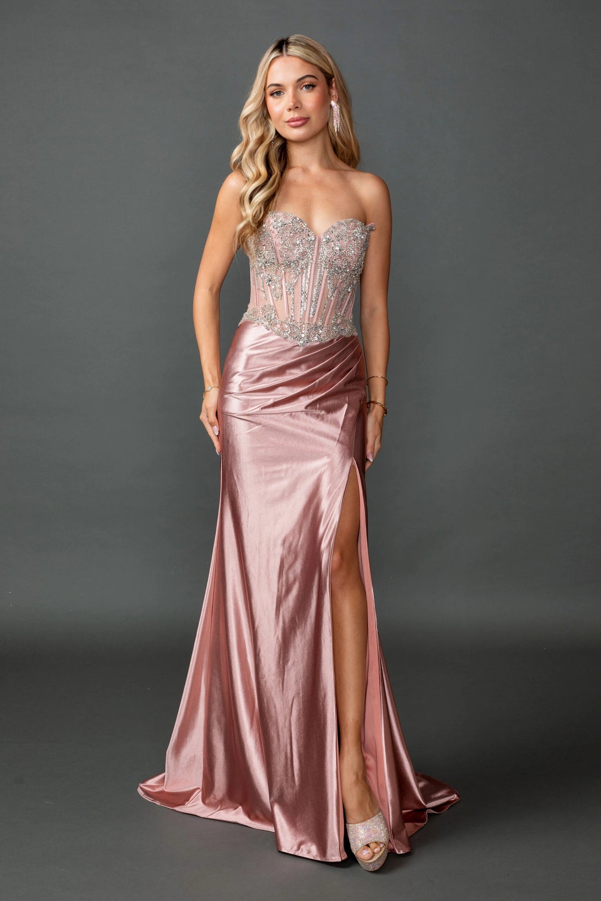 Featuring a floor-length skirt, this Rose Gold prom dress is shown in full view.