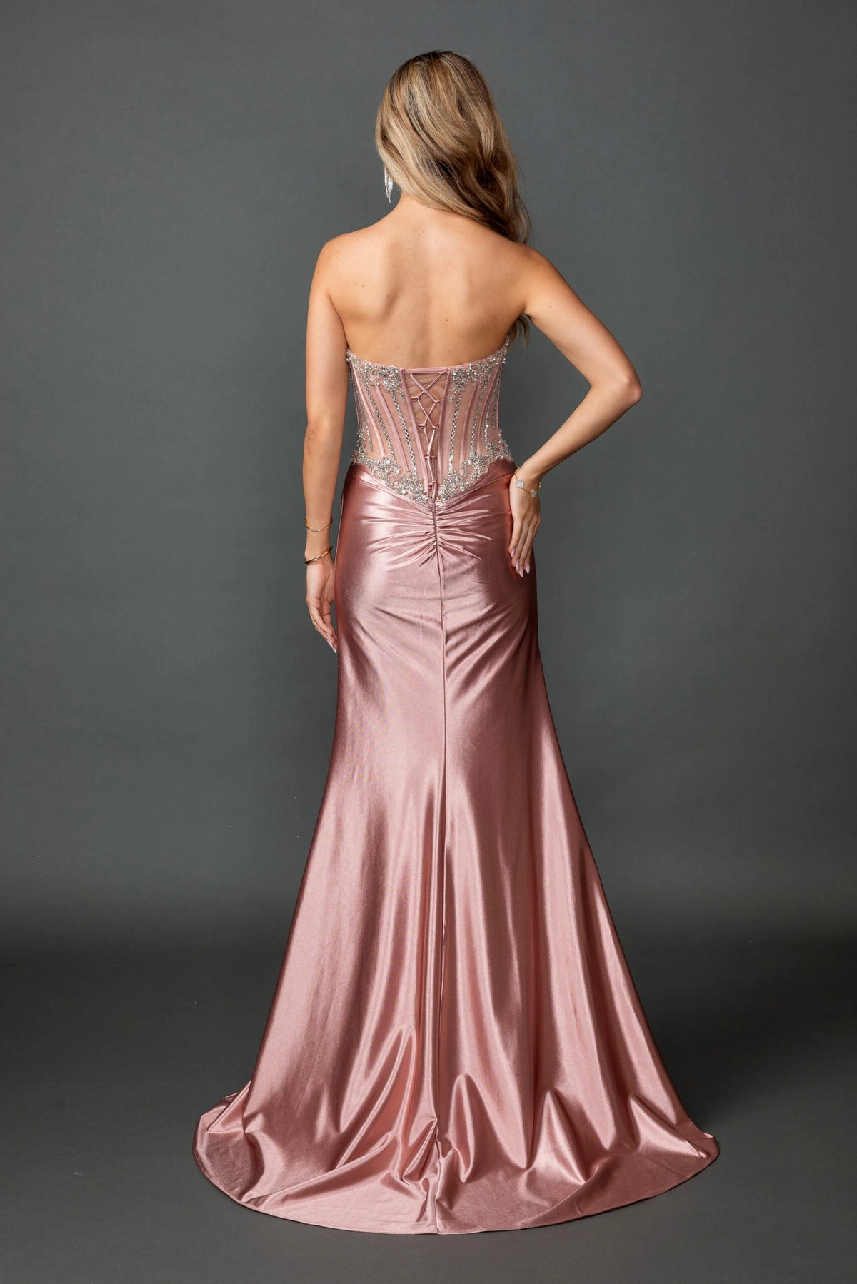 From the back, the Rose Gold prom dress reveals its floor-length skirt.