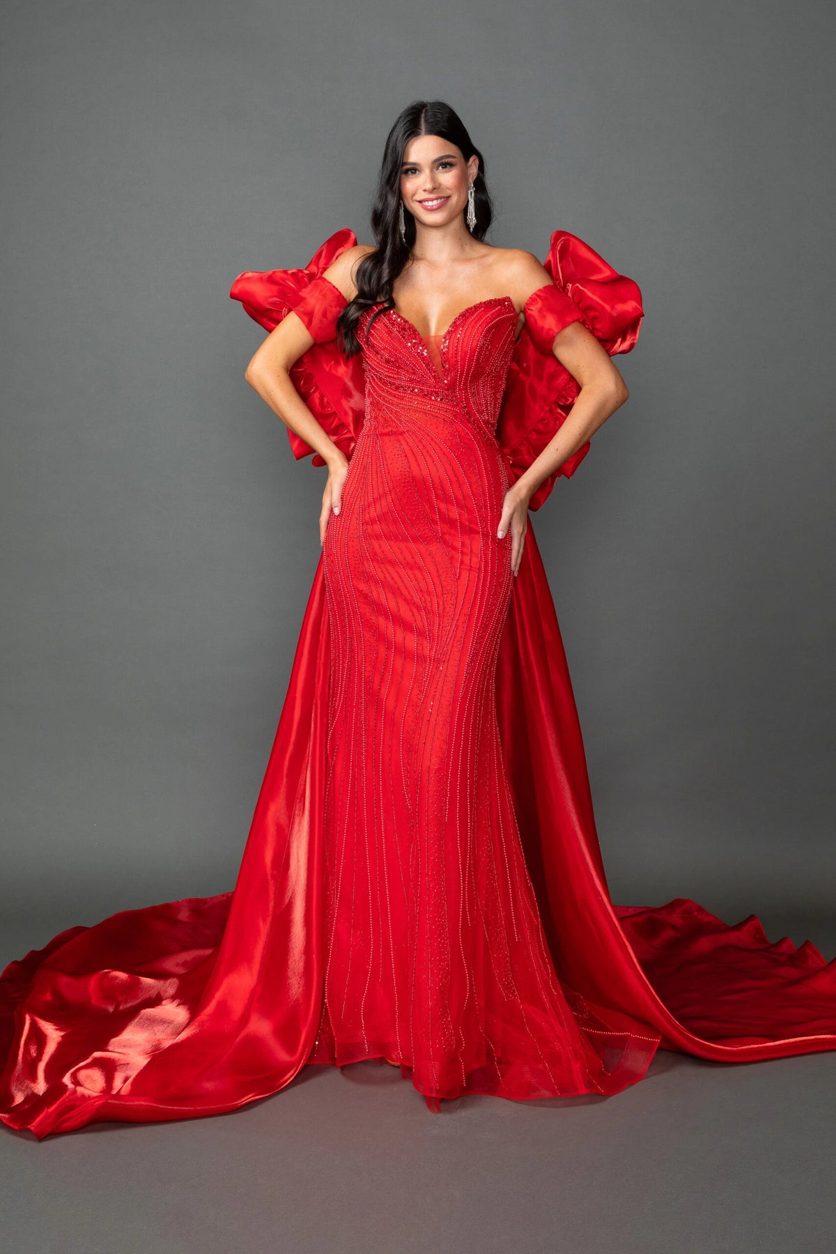 From the front, the Red prom dress reveals its floor-length skirt.