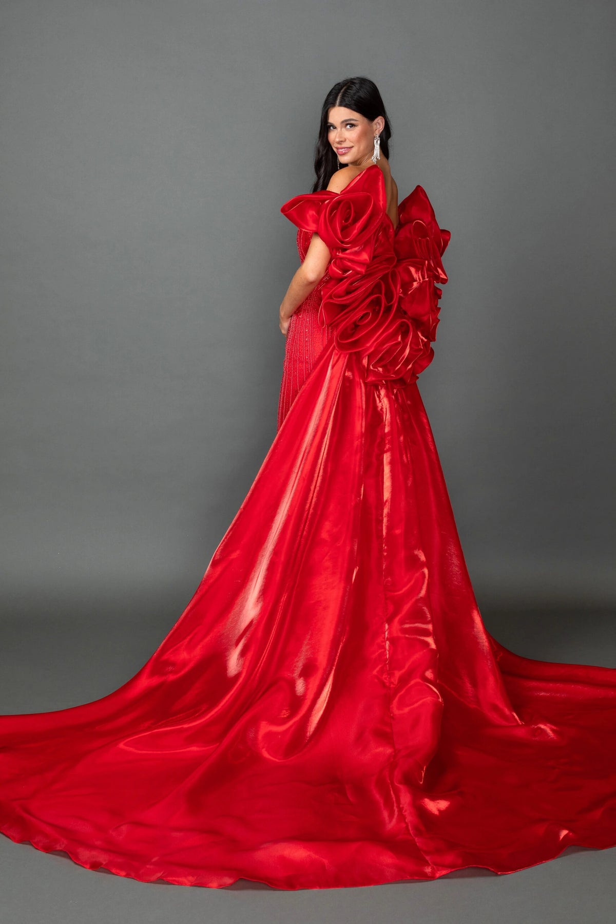 Showing its floor-length skirt, the Red prom dress highlights the garment construction.