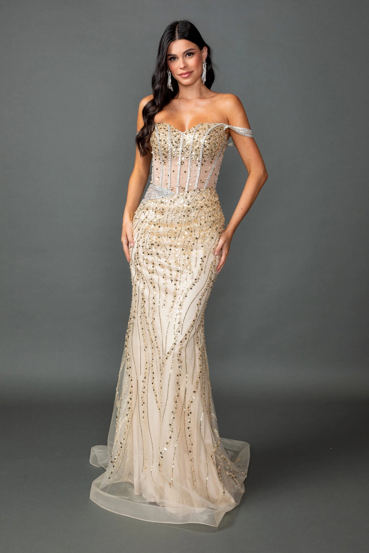 Featuring a floor-length skirt, this Champagne prom dress is shown in full view.