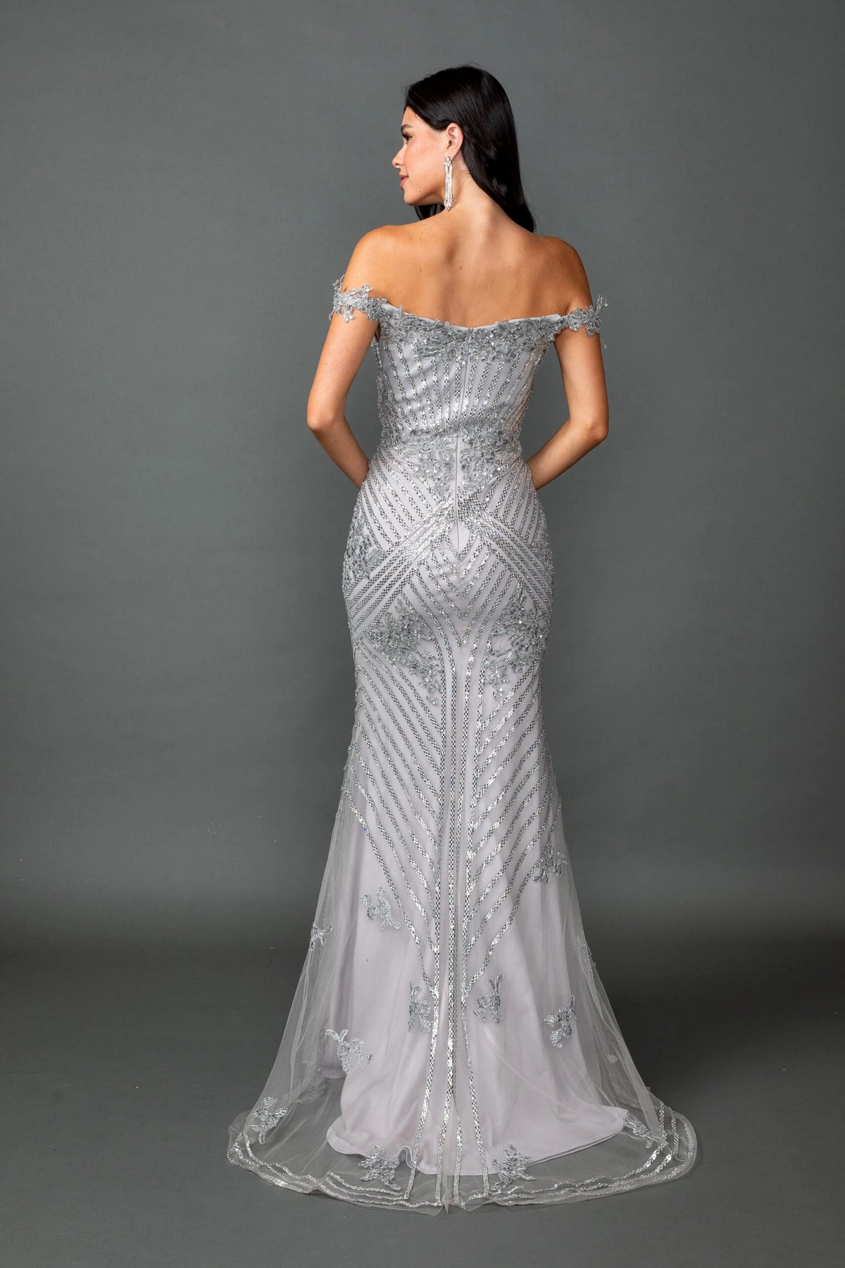 From the back, the Silver prom dress reveals its floor-length skirt.
