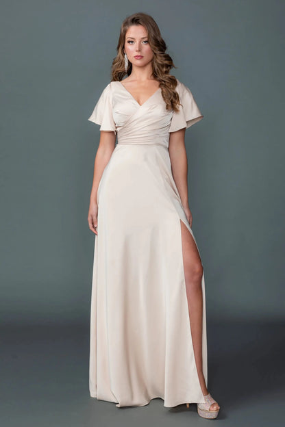 Woman in Champagne V-neck prom dress with ruched bodice and slit A-line skirt.