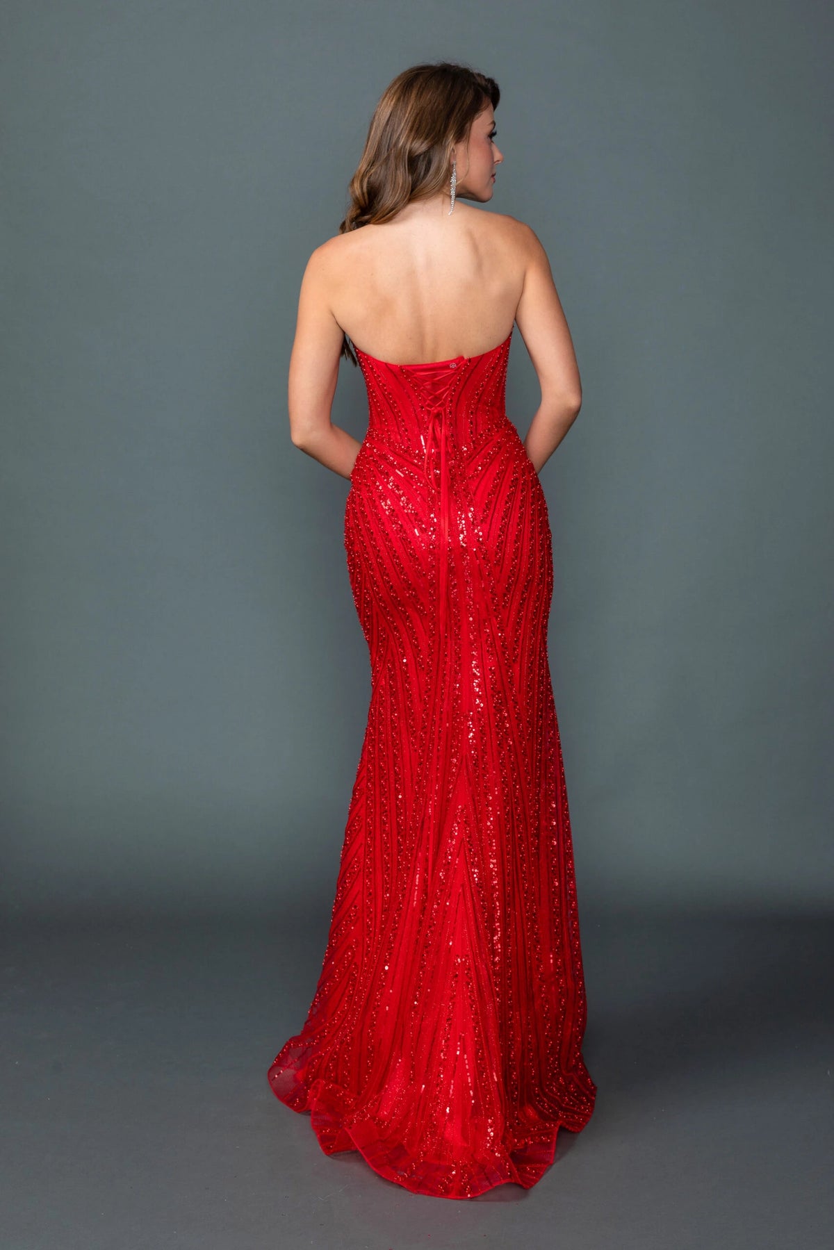 From the back, the Red prom dress reveals its floor-length skirt.