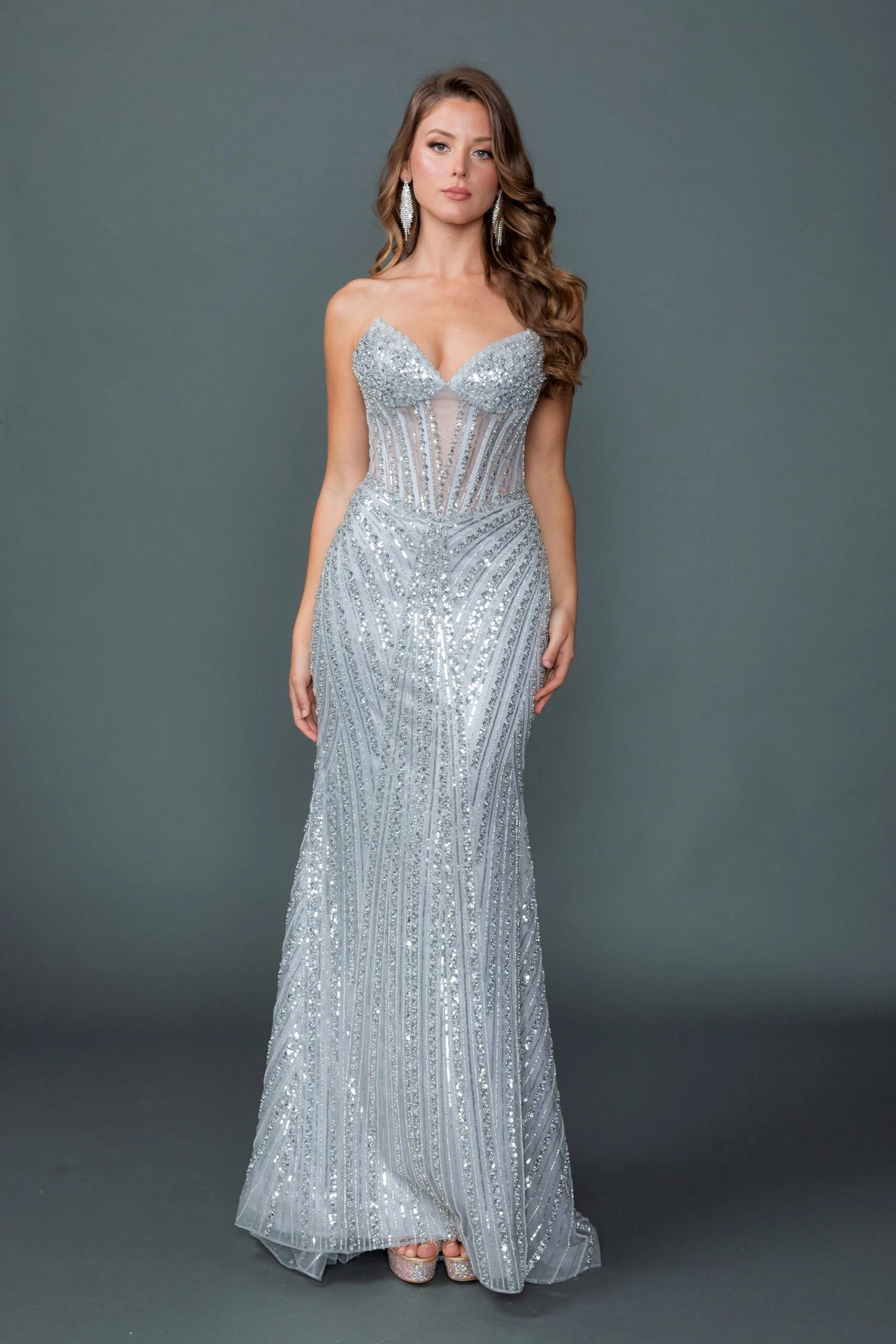 Featuring a floor-length skirt, this Silver prom dress is shown in full view.