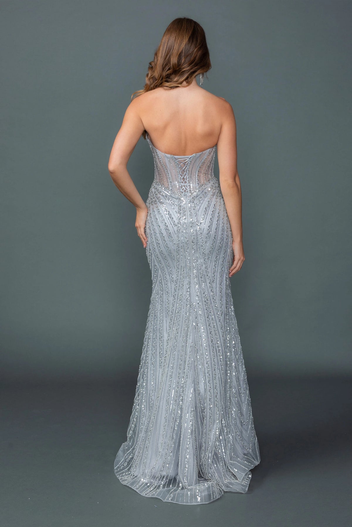From the back, the Silver prom dress reveals its floor-length skirt.