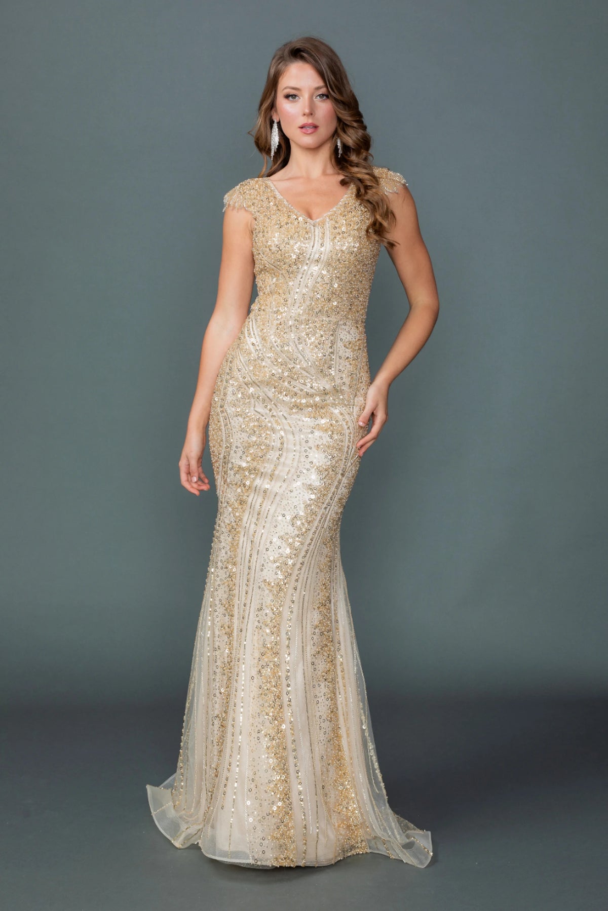 Featuring a floor-length skirt, this Champagne prom dress is shown in full view.