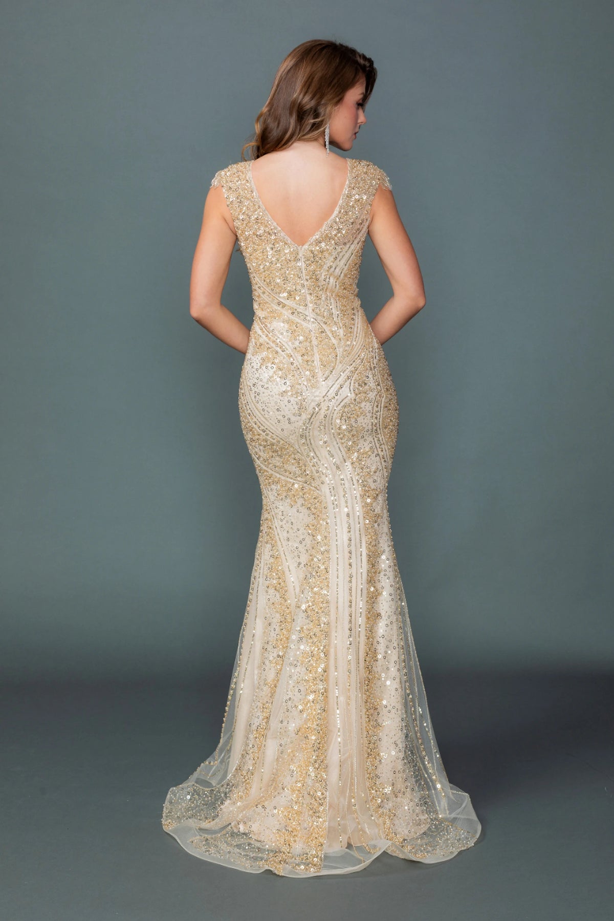 From the back, the Champagne prom dress reveals its floor-length skirt.