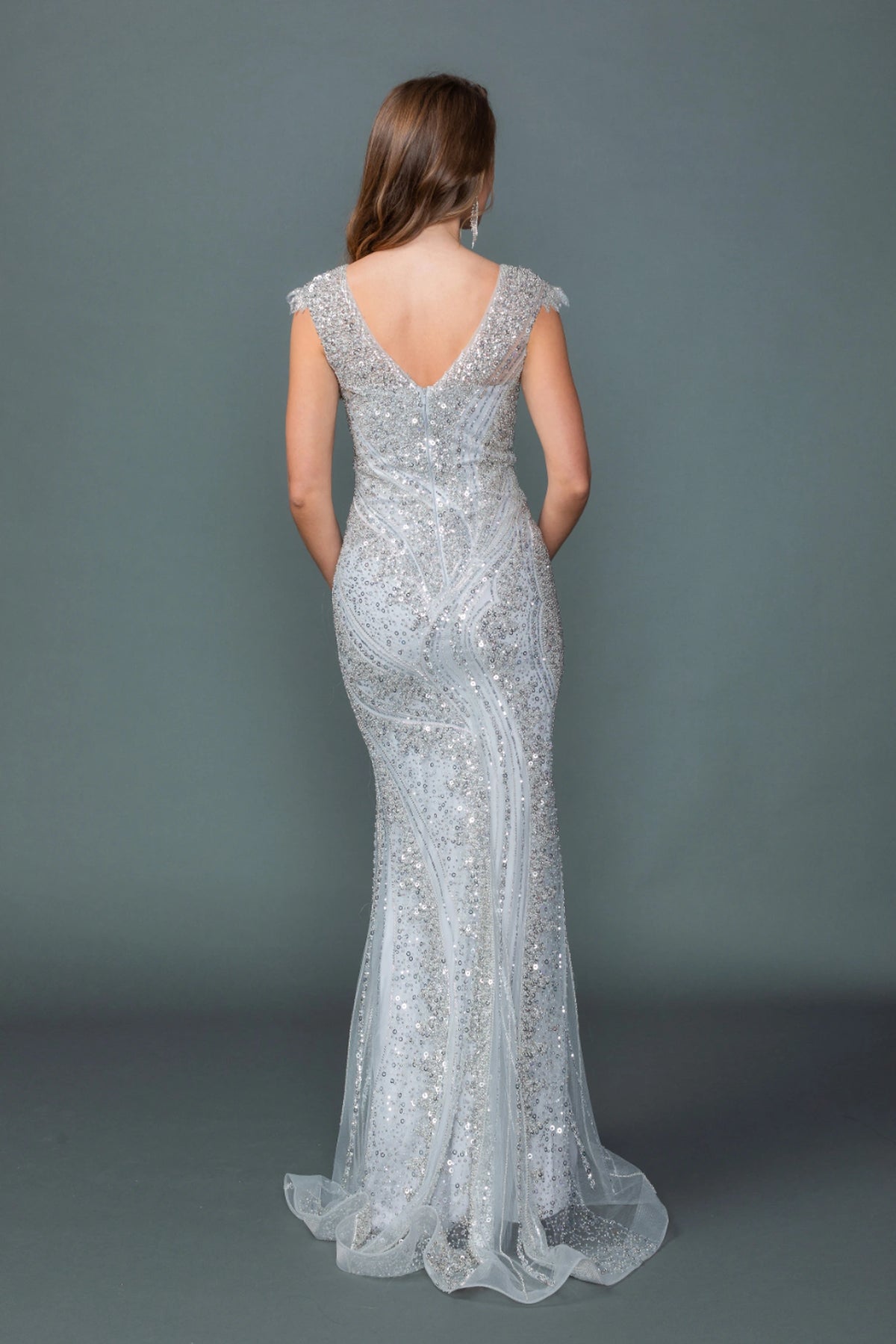 From the back, the Silver prom dress reveals its floor-length skirt.