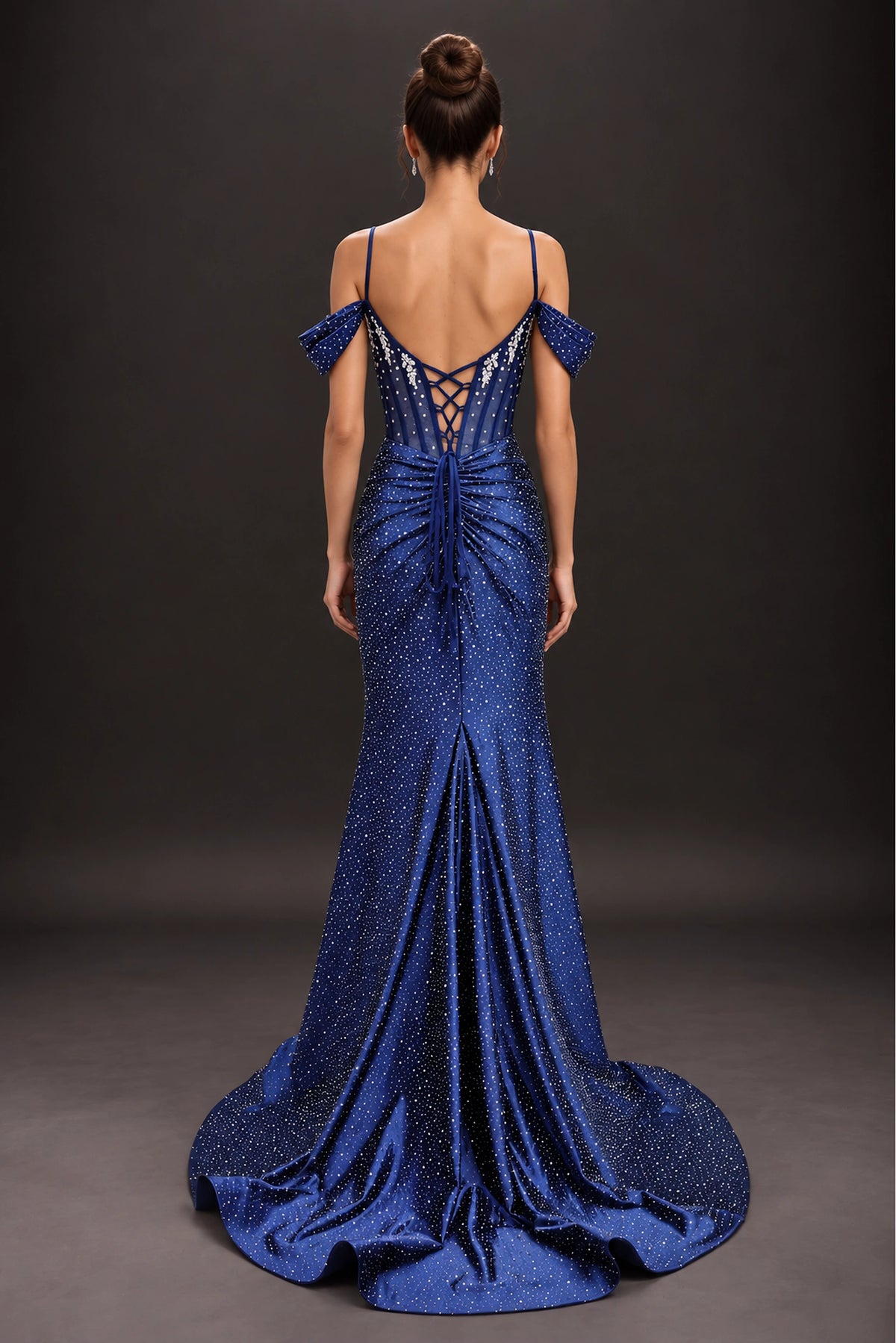 From the back, the Navy prom dress reveals its floor-length skirt.