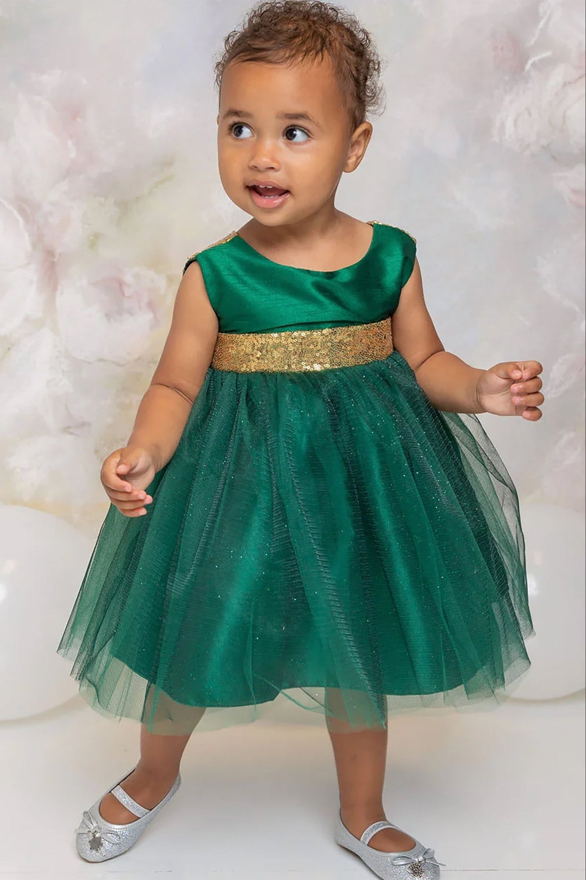 A green flower girl dress with a gold belt.