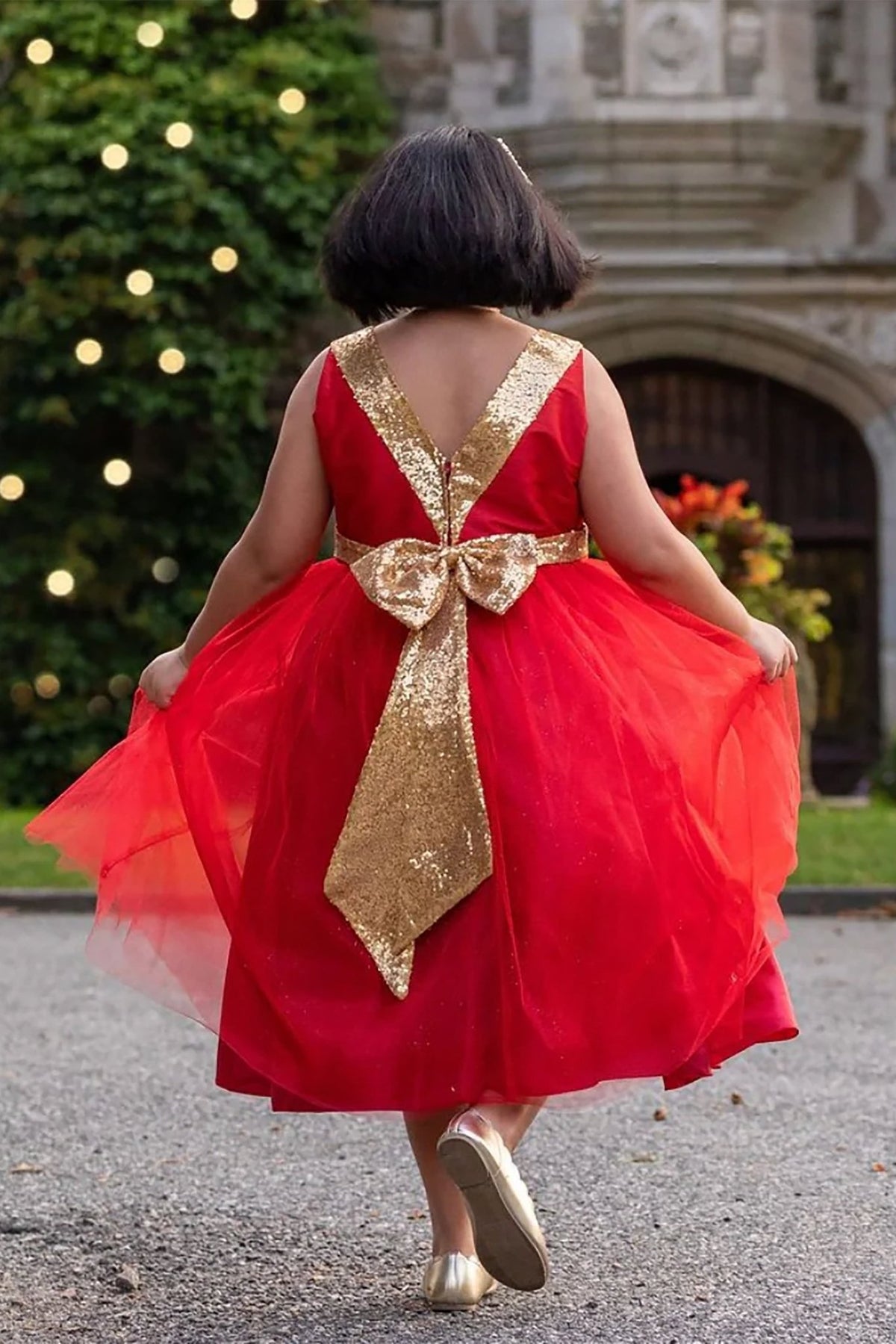 Red flower girl dress with a gold bow back.