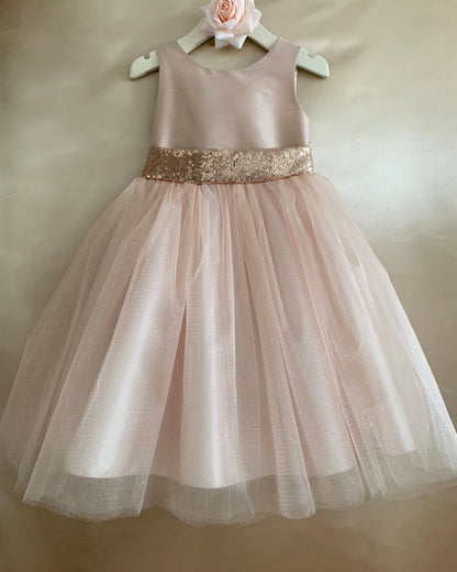 Textured details appear across Rose Gold flower girl dress with a gold sequin belt.