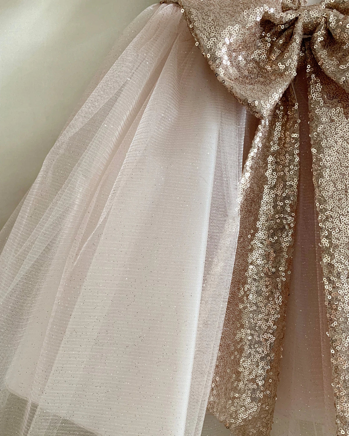 Close-up of a decorative bow with tulle and sequins. Flower girl dress.