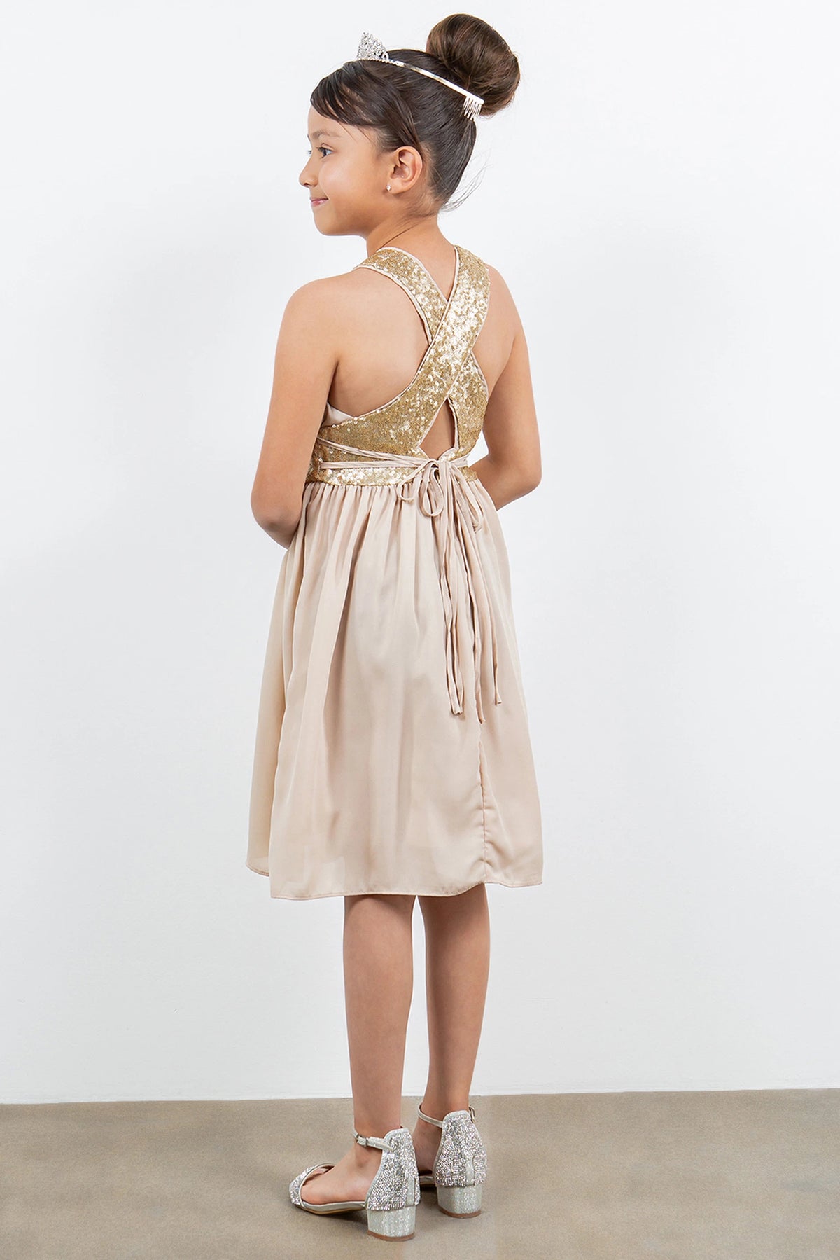 Showcasing with crossed sequin-trimmed back straps, this Champagne kids party dress displays elegant detail.