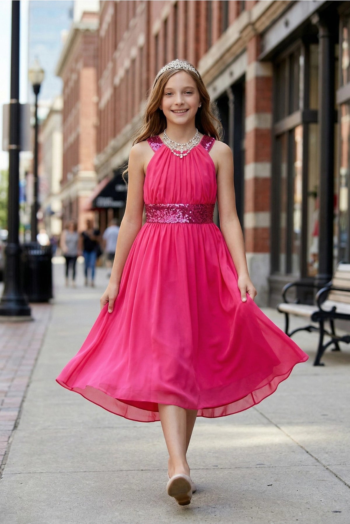 Showcasing with a sparkling sequin waistband, this Fuchsia kids party dress displays elegant detail.