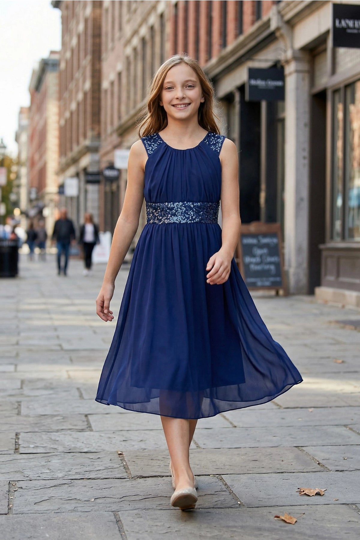Showcasing with a sparkling sequin waistband, this Navy kids party dress displays elegant detail.