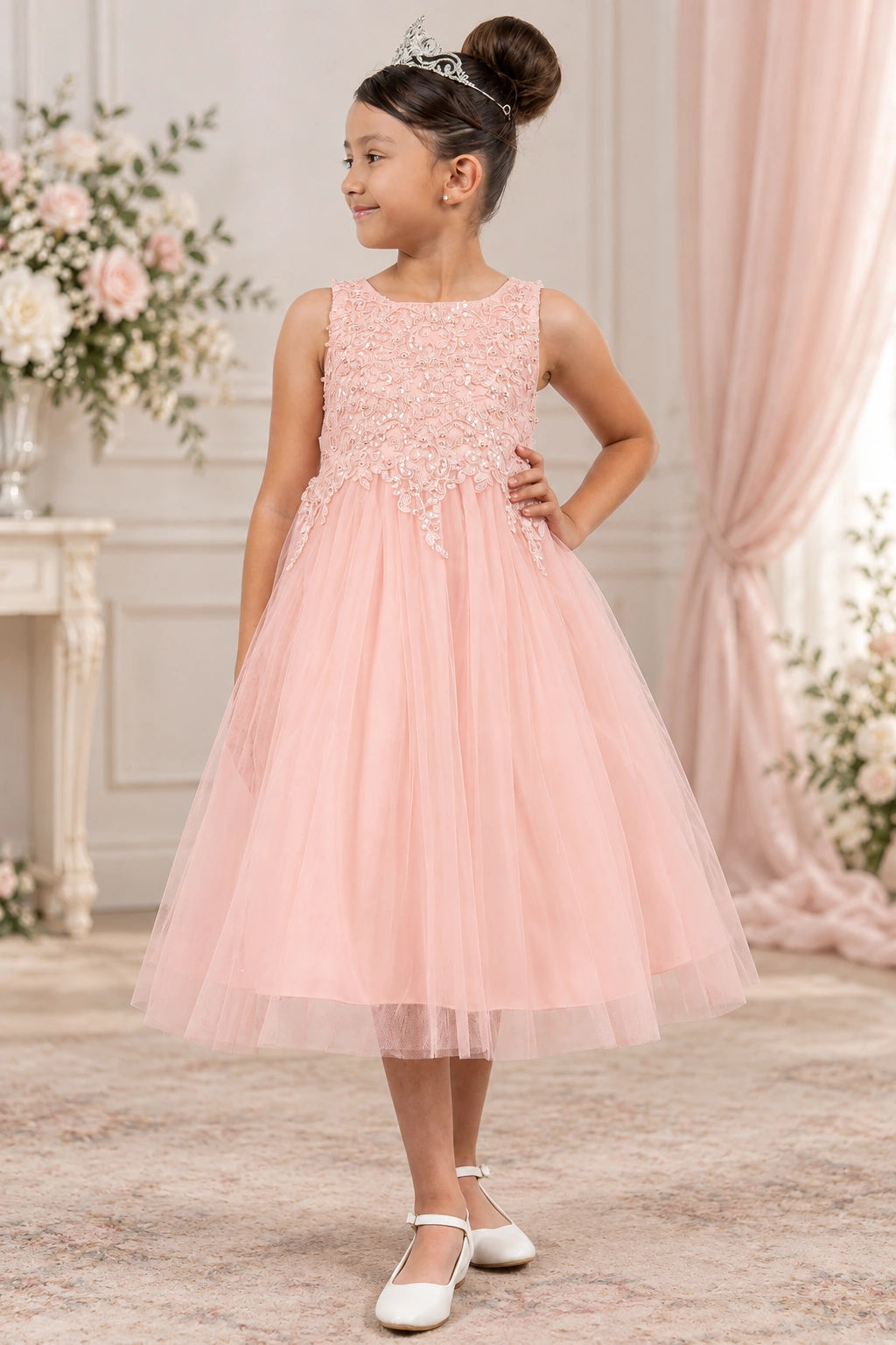Blush flower girl dress with a textured floral bodice and a softly gathered tulle skirt.