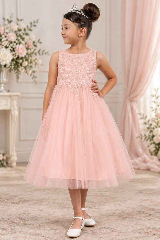Blush flower girl dress with a textured floral bodice and a softly gathered tulle skirt.