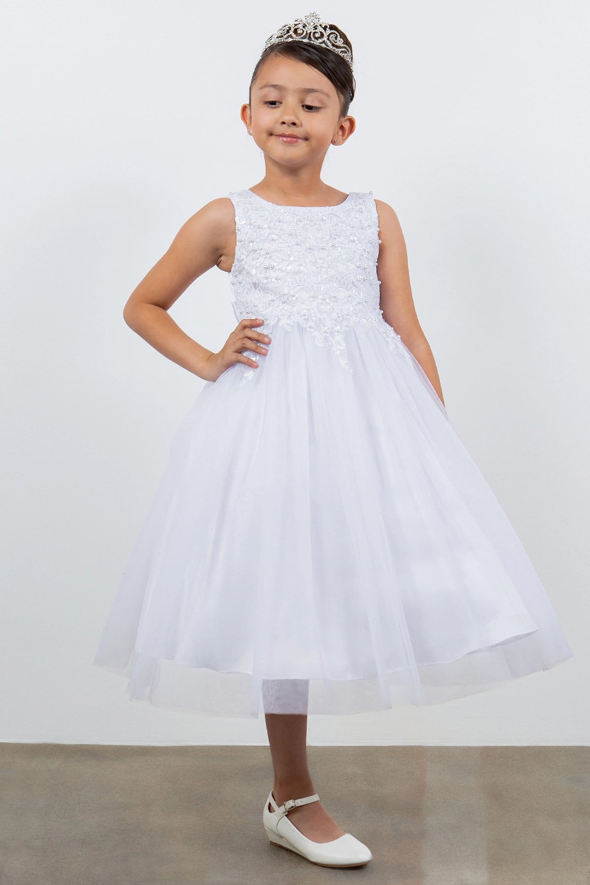 White flower girl dress with pearl sequins and a full tea-length tulle skirt.