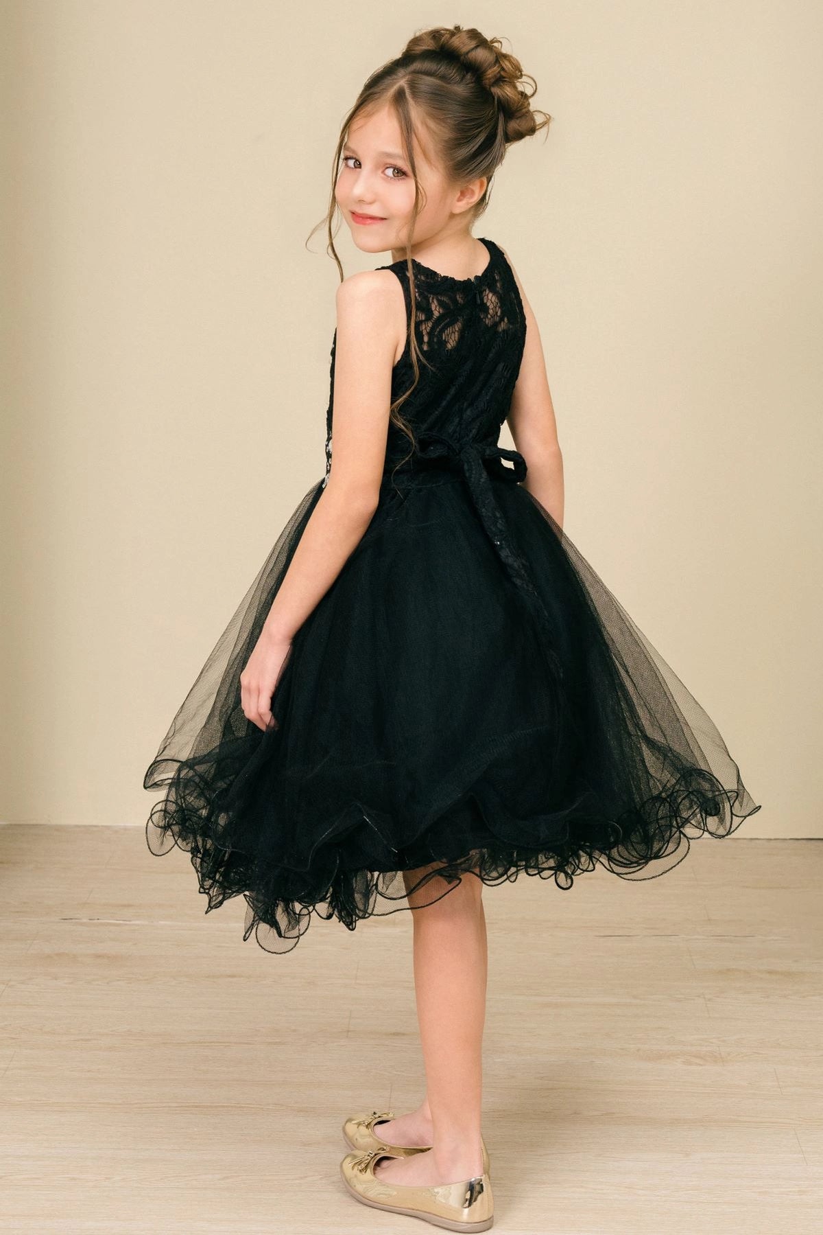 Showcasing with a lace back and satin bow, this Black kids party dress displays elegant detail.