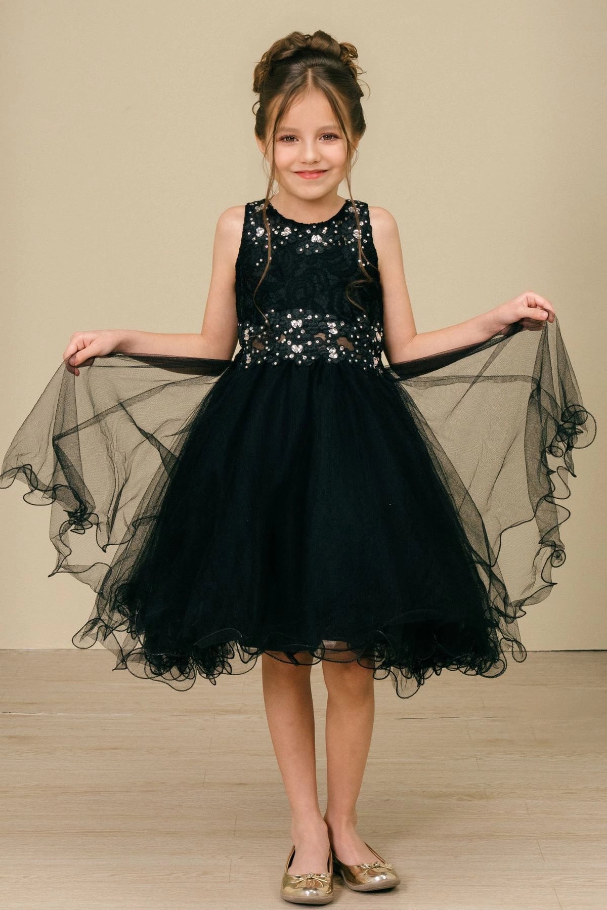 Accented a layered tulle skirt adds character to this Black kids party dress.