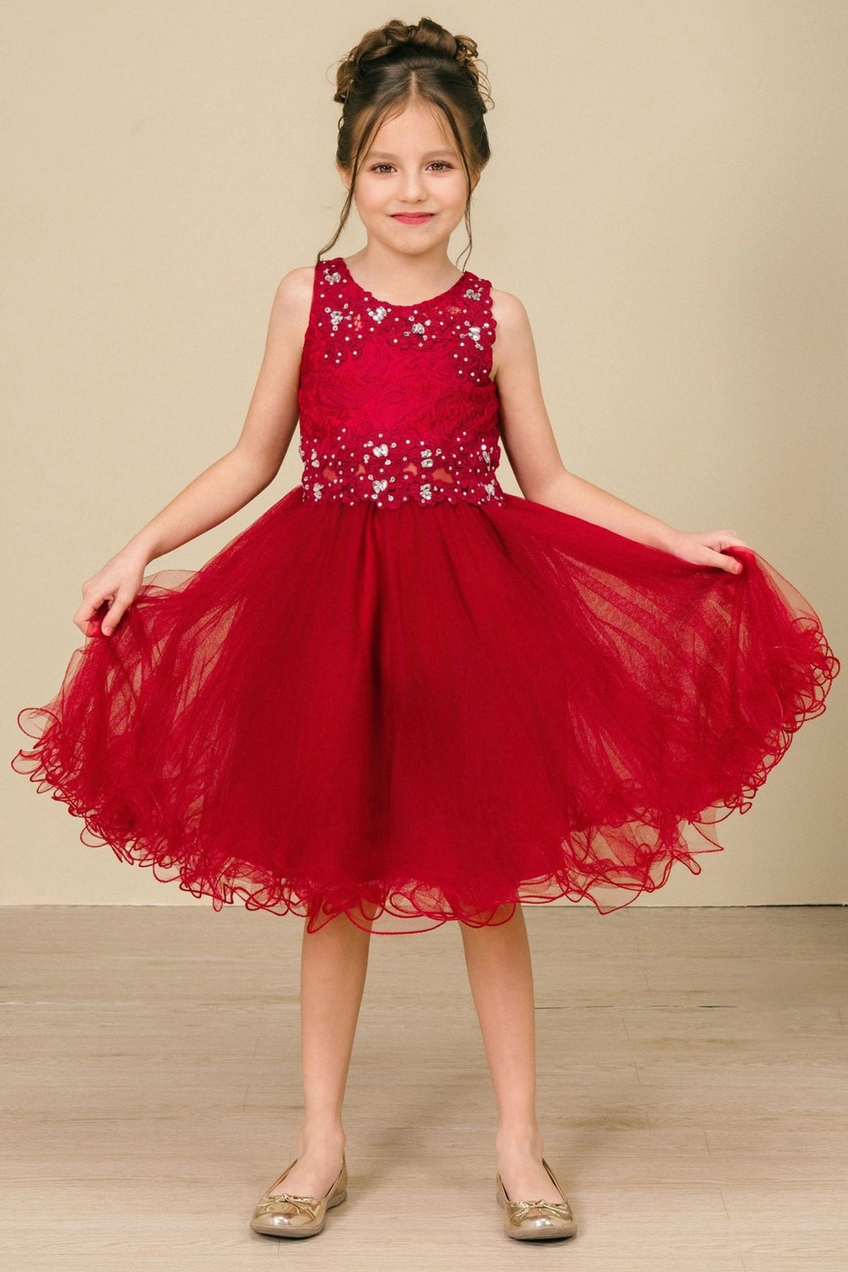 Detailed by a layered tulle skirt, the Burgundy kids party dress reveals its construction.