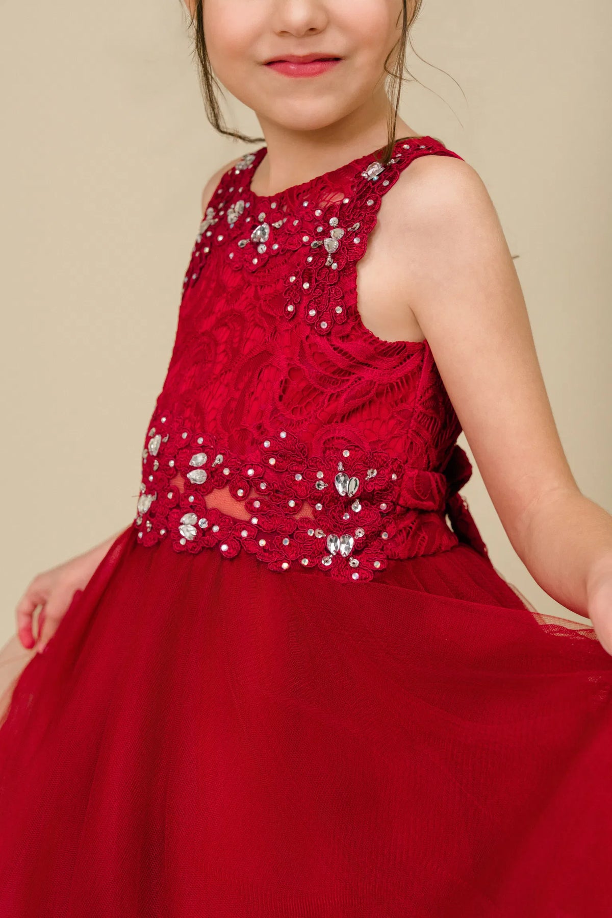 Finished details of beaded floral lace on the bodice distinguish the Burgundy kids party dress.
