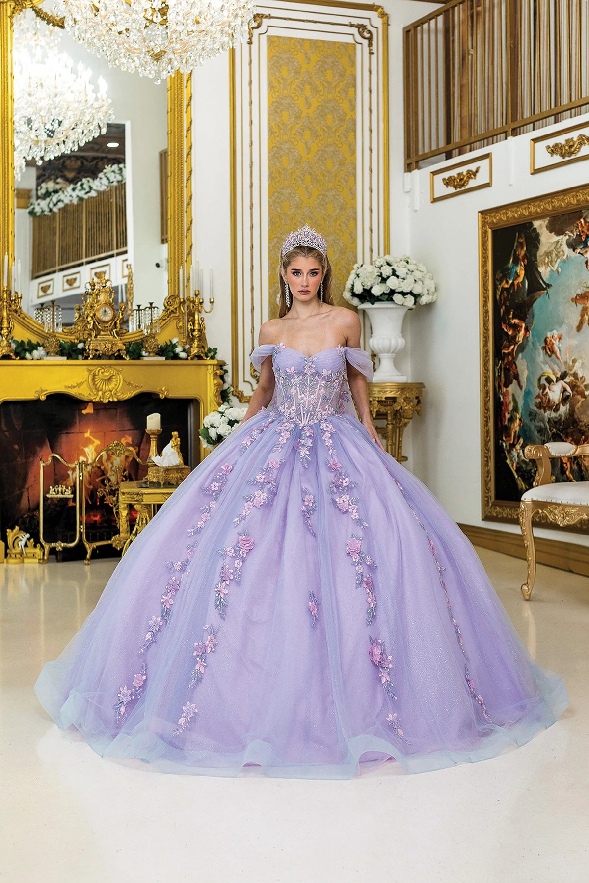 Front view of a Bahama/Lilac quinceañera gown with off-the-shoulder neckline, puff sleeves, sheer corset bodice, and 3D floral appliqués