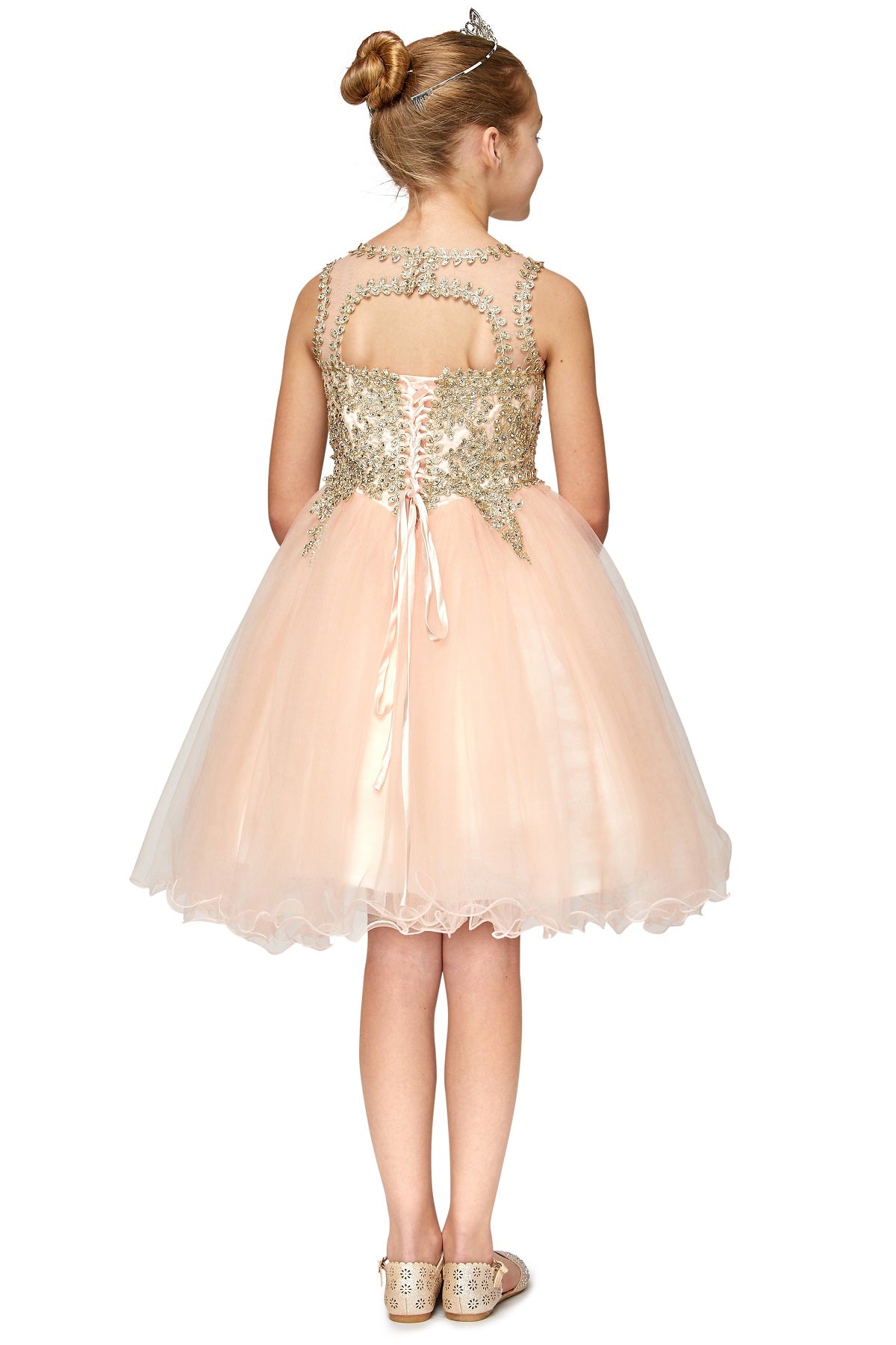 Blush flower girl dress back view highlighting flowing tulle skirt and elegant silhouette.