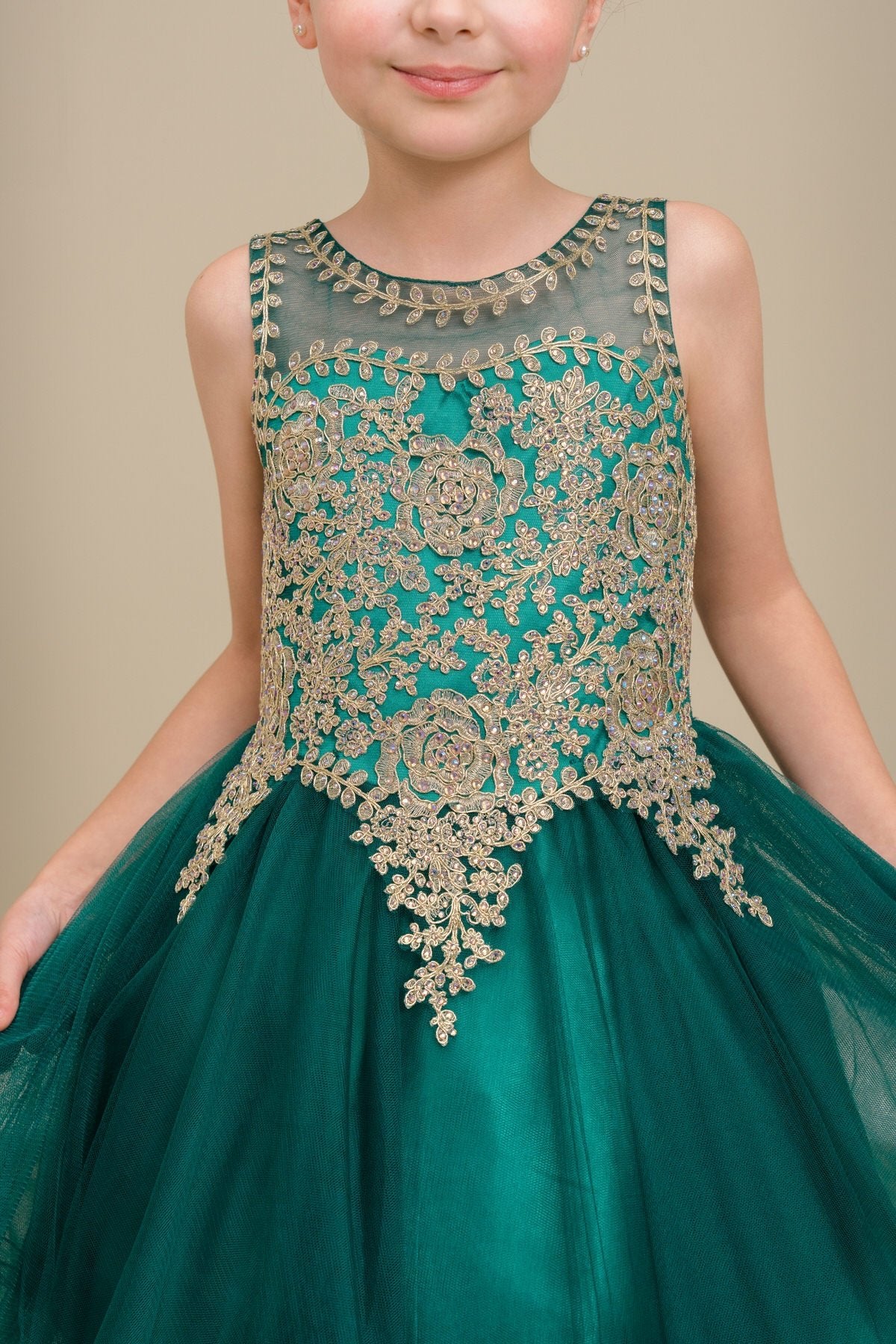 Close-up front view of hunter green flower girl dress showing floral applique and pearl detail.