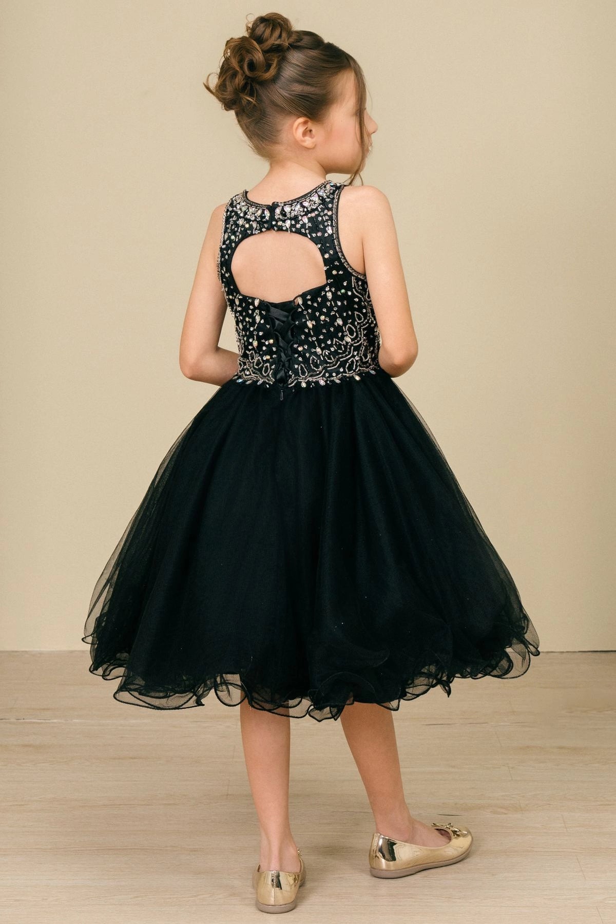 Finished details of a beaded keyhole back distinguish the Black kids party dress.