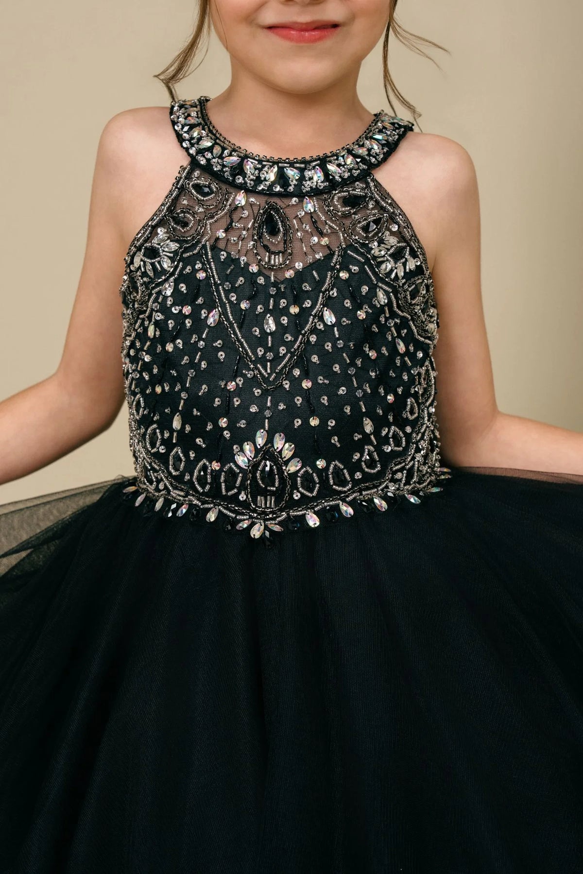 Accented crystal beading across the bodice adds character to this Black kids party dress.
