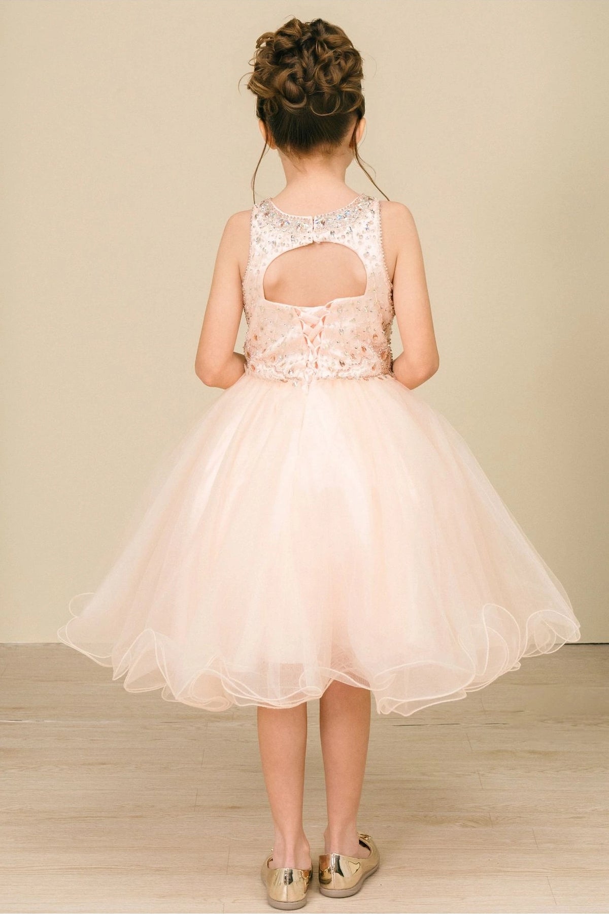 Finished details of a beaded keyhole back distinguish the Blush kids party dress.