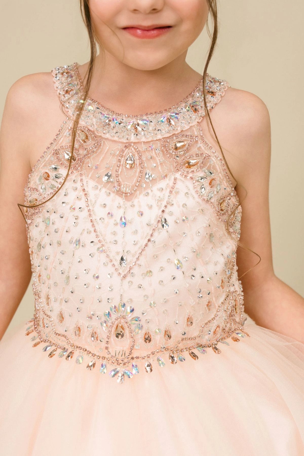 Detailed by crystal beading across the bodice, the Blush kids party dress reveals its construction.