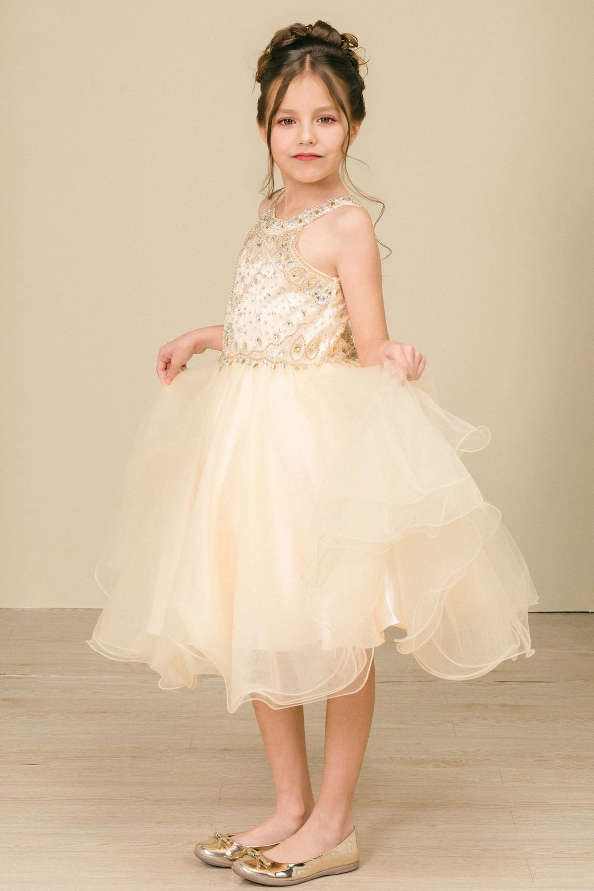 Accented a full tulle skirt adds character to this Champagne kids party dress.