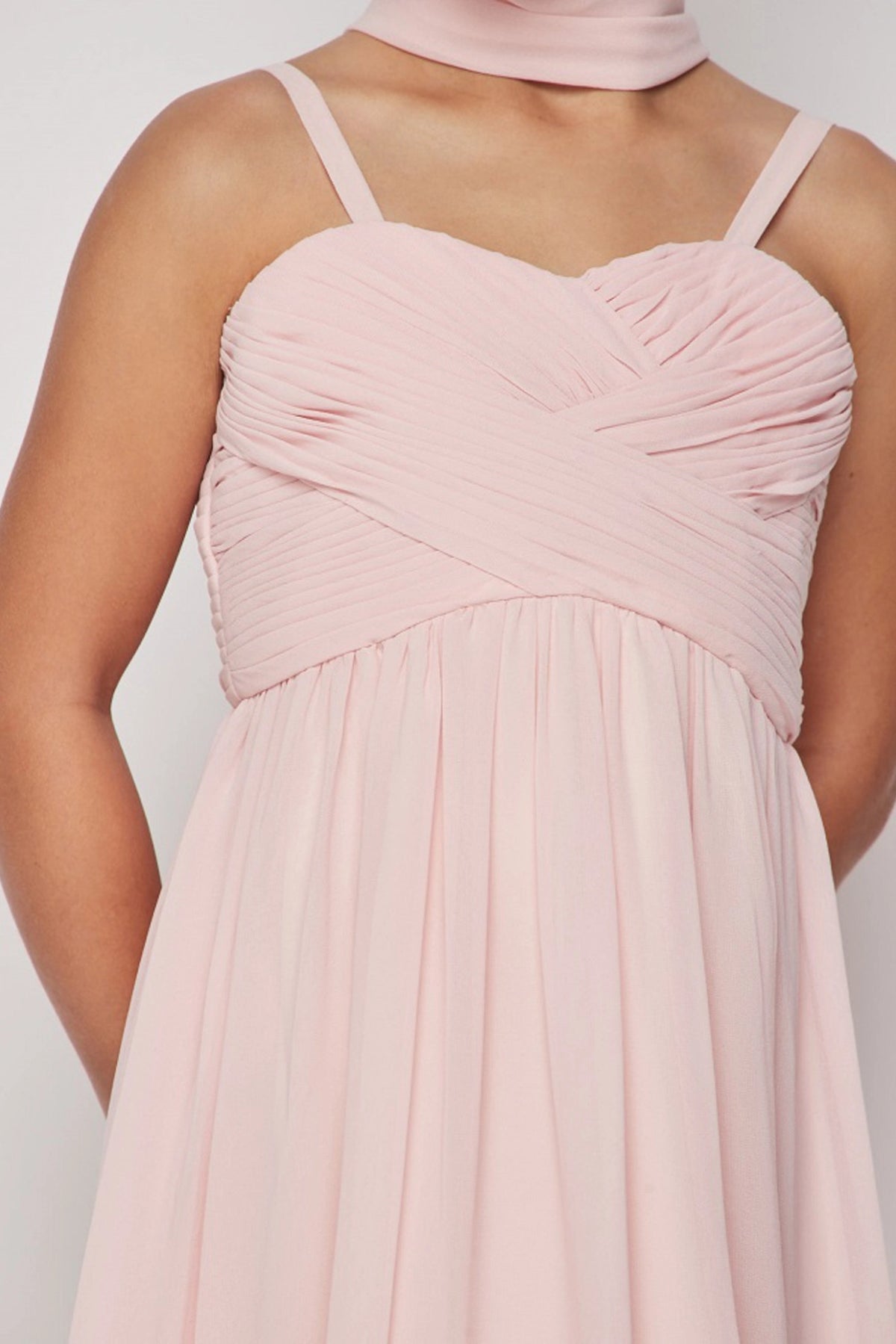 Overlapping pleats shape the neckline of the Blush kids party dress.