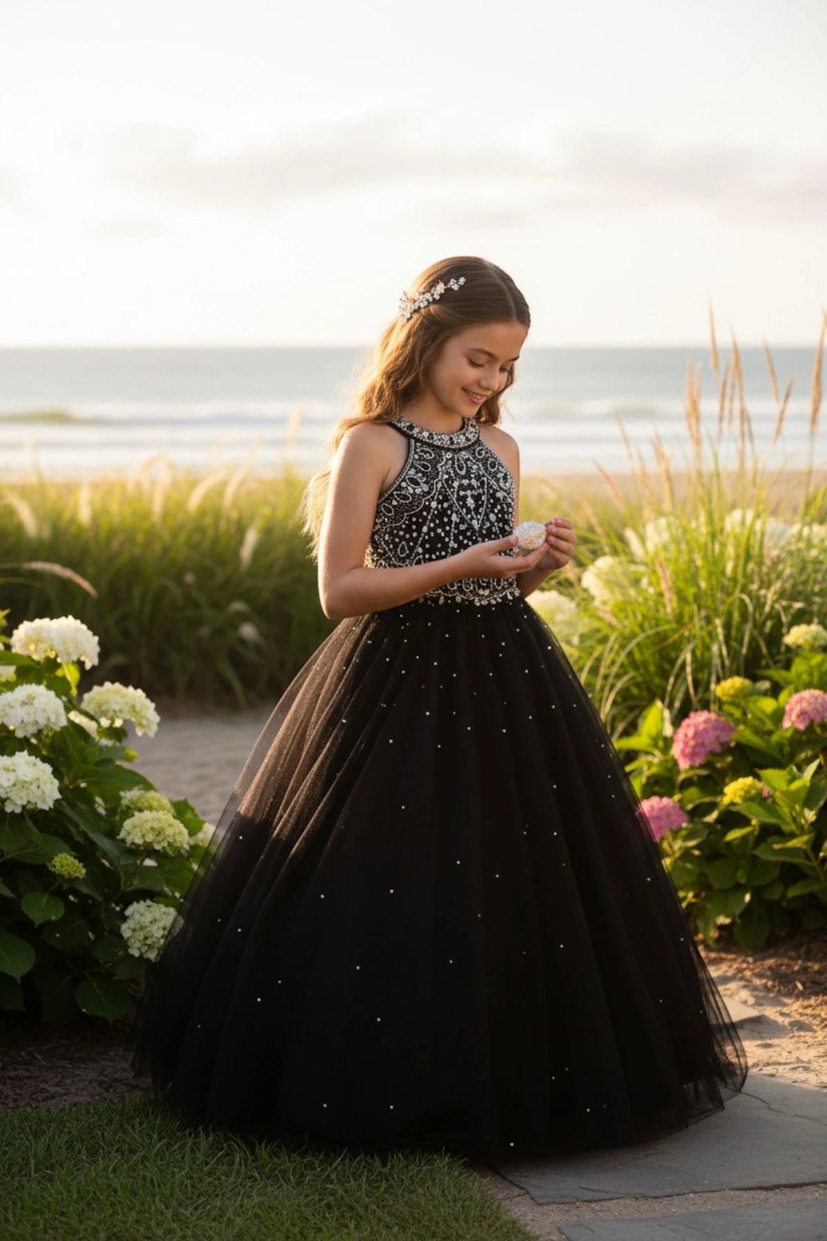 Details of this Black mini quince dress include sparkling bodice beads and a flowing skirt.