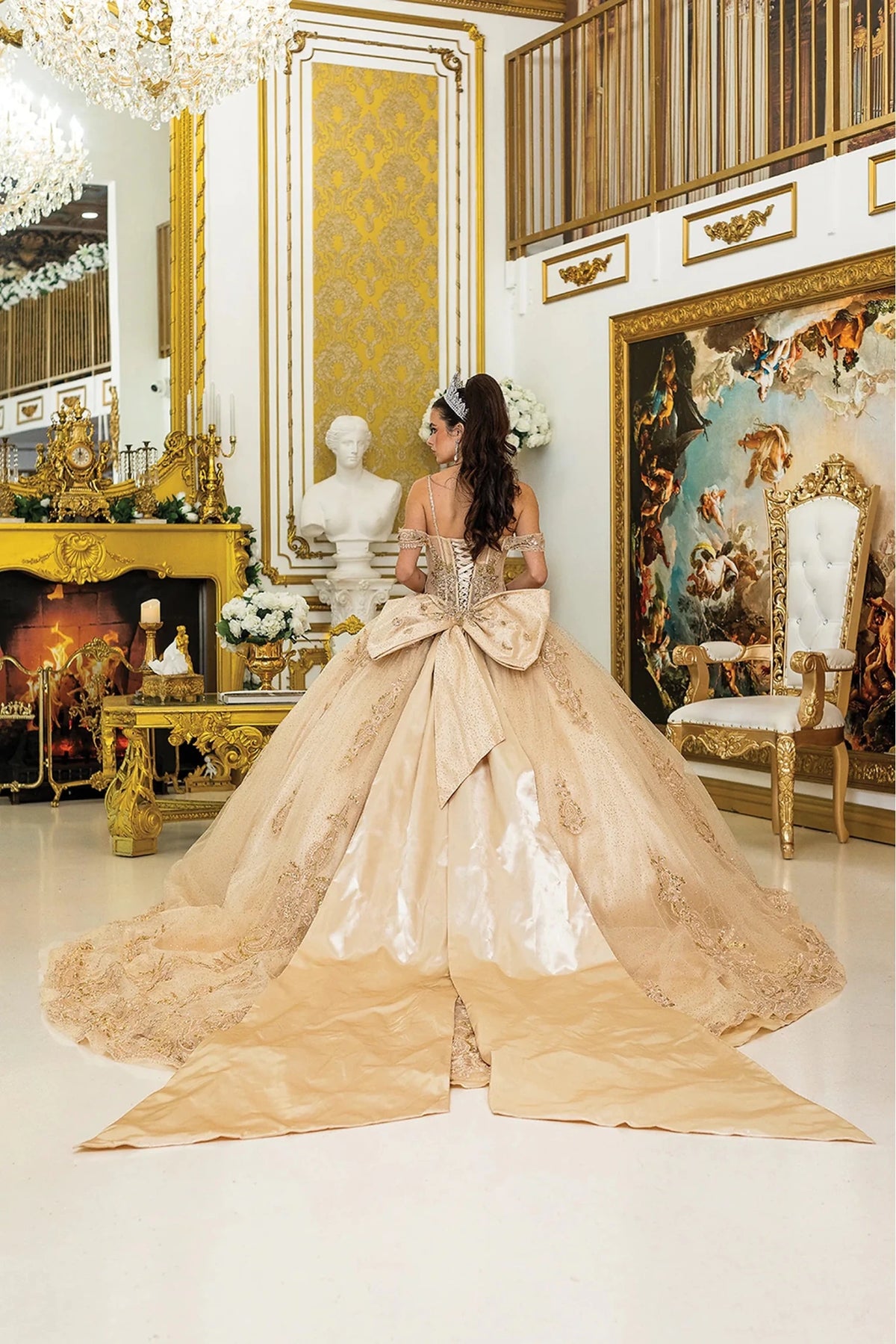 From the back, the Gold quinceañera ball gown reveals its floor-length skirt.