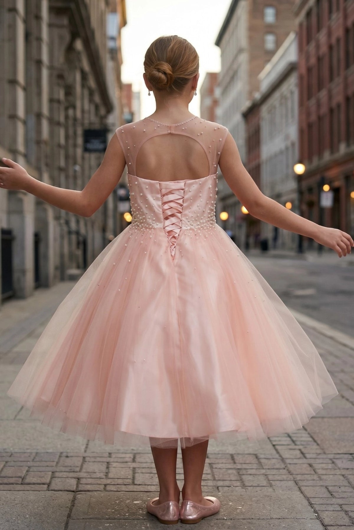 Showcasing with crisscross back lacing, this Blush kids party dress displays elegant detail.