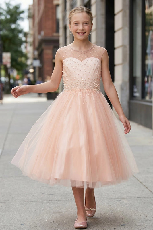 Detailed by a layered tulle skirt, the Blush kids party dress reveals its construction.
