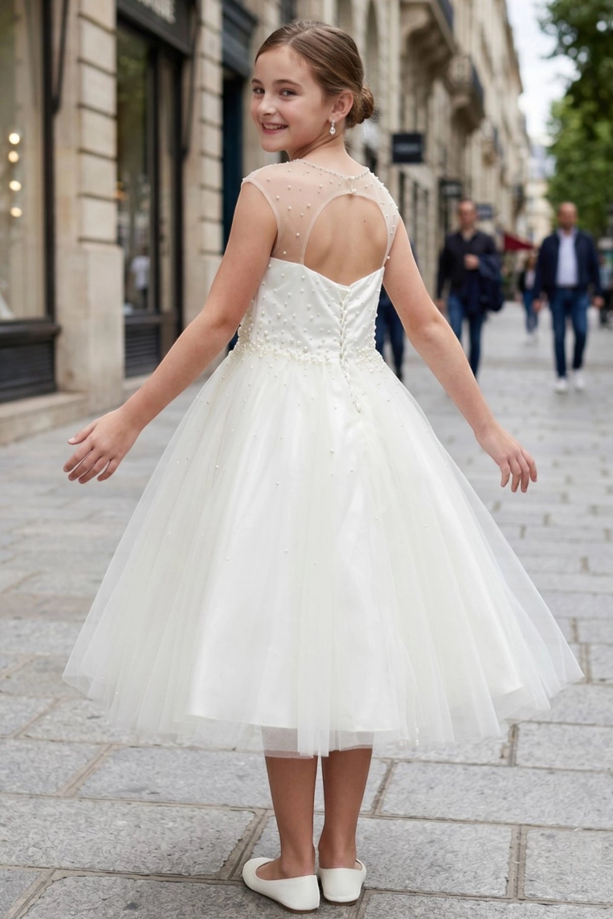 Detailed by crisscross back lacing, the Ivory kids party dress reveals its construction.