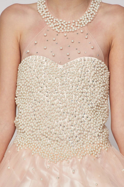 Showcasing pearls over the illusion halter bodice on the Blush mini quince dress.