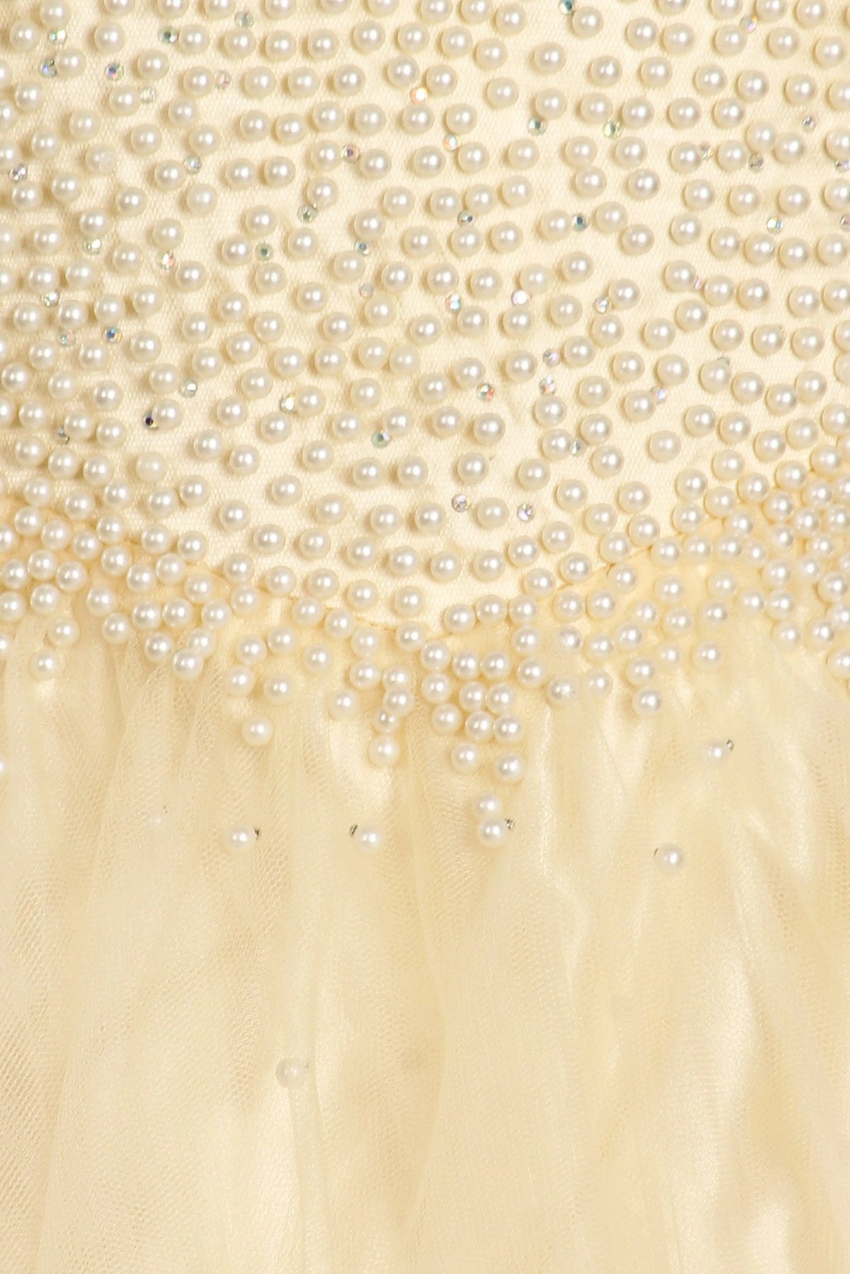 Showcasing pearls along the bodice and waist on the Champagne mini quince dress.