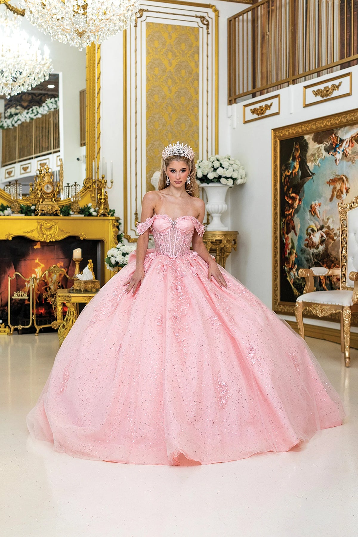 Front view of a Blush quinceañera gown with off-the-shoulder neckline, corset bodice, and floral appliqués