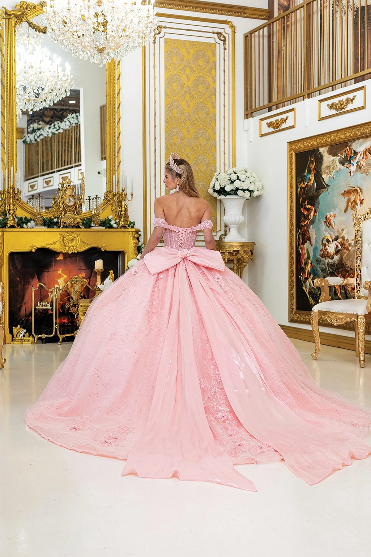 Rear view of a Blush quinceañera gown showing lace-up back and floral appliqués