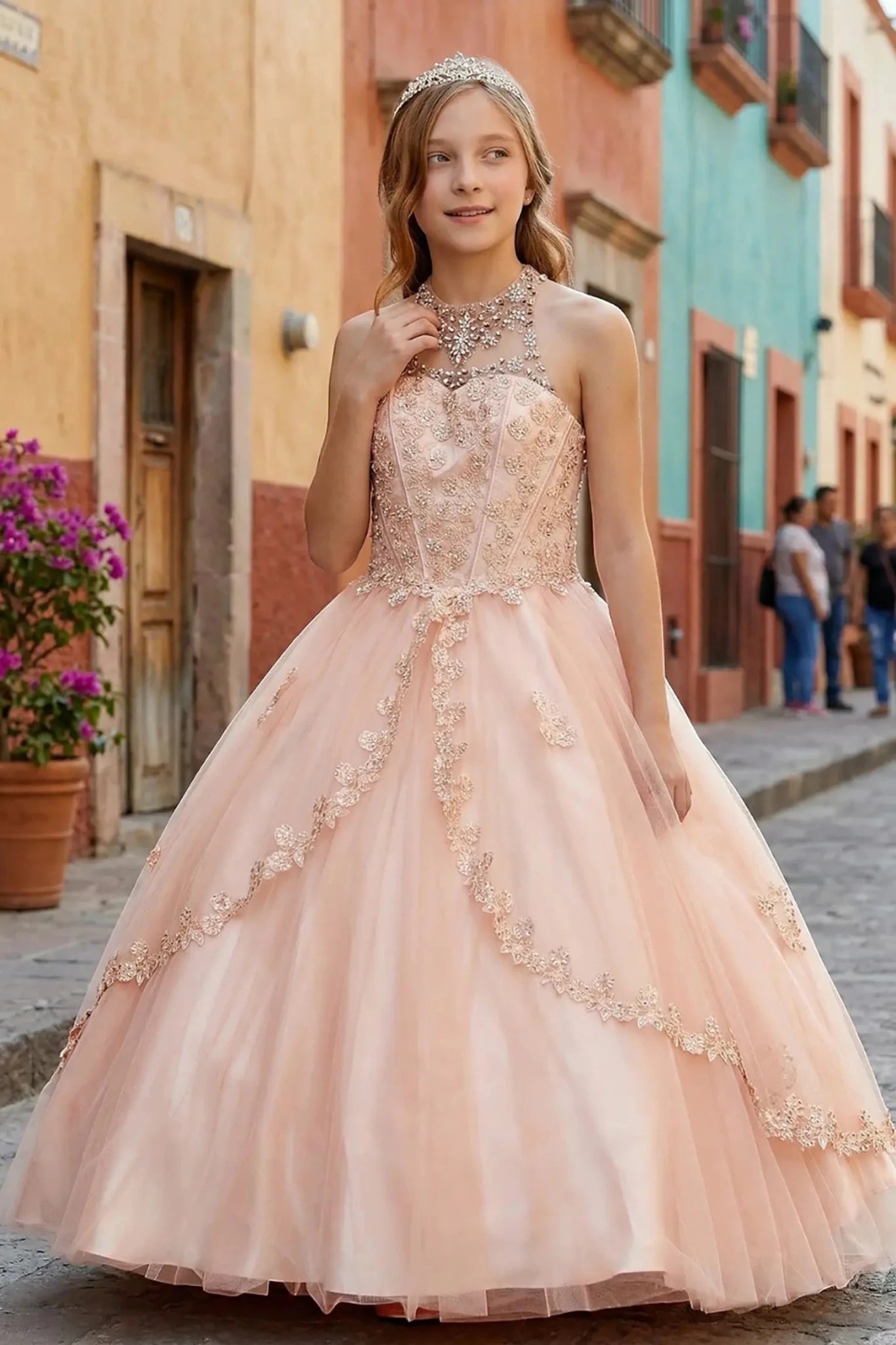 Blush front view kids mini quinceañera mini quince dress with halter neck, rhinestones, pearls and layered tulle skirt.