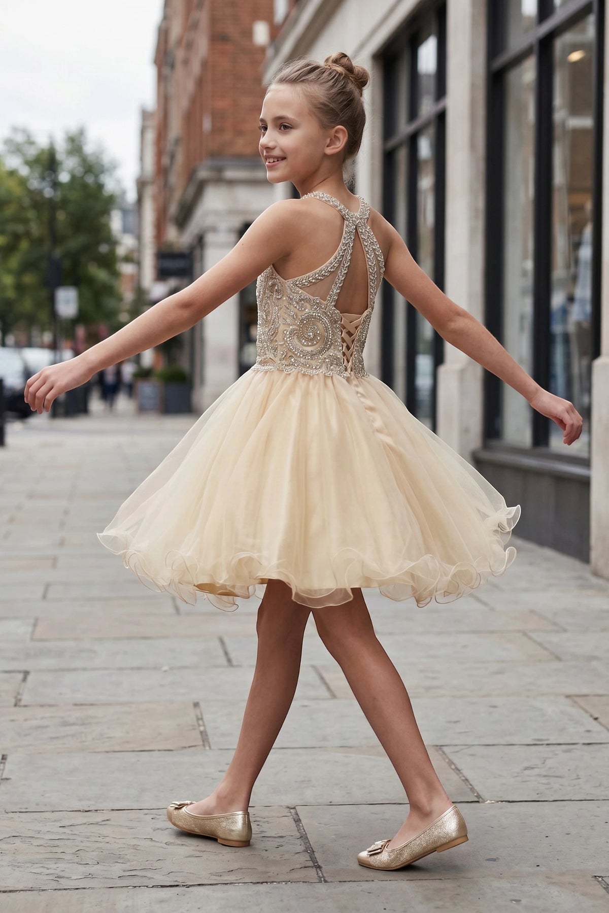 Showcasing with crossed halter straps, this Champagne kids party dress displays elegant detail.
