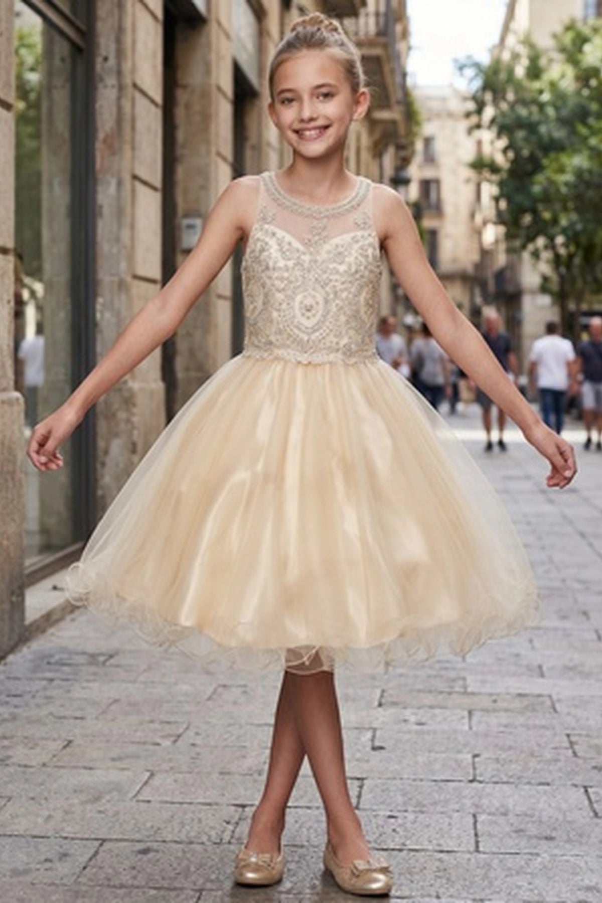 Finished details of a layered tulle skirt distinguish the Champagne kids party dress.